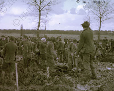 [WWII Color Photograph: German PWs on grave detail. Copyright HWL Images.]