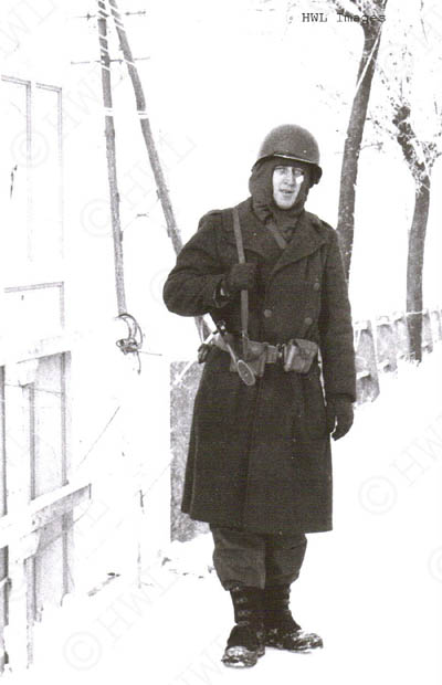 [WWII Photograph: Harold Luetjen guarding a bridge in Luxembourg, Winter 1944-45. Copyright HWL Images.]