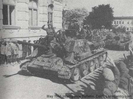 [The crew of an 85-mm SP gun and tank destroyer, on a T34 tank chassis, ride their weapon through a town in Rumania. These weapons are organic equipment of the two tank regiments within the Soviet cavalry corps.]