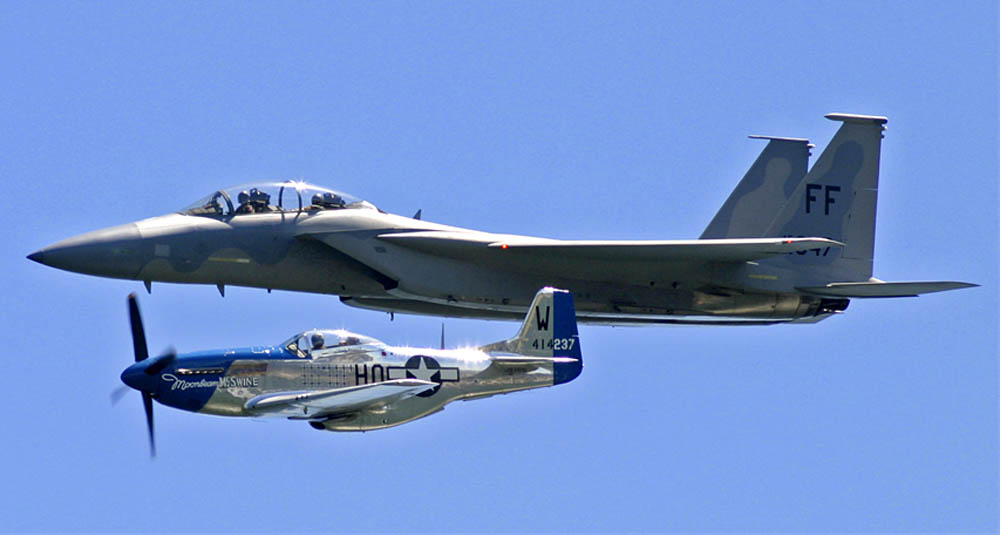 A North American P-51 Mustang flies in formation with an F-15E Strike Eagle during an air show in Milwaukee. (U.S. Air Force Photograph / MSgt. Kenneth Pagel.)