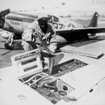 An armorer of the 15th U.S. Air Force checks ammunition belts of the .50 caliber machine guns in the wings of a P-51 Mustang fighter plane before it leaves an Italian base for a mission against German military targets.