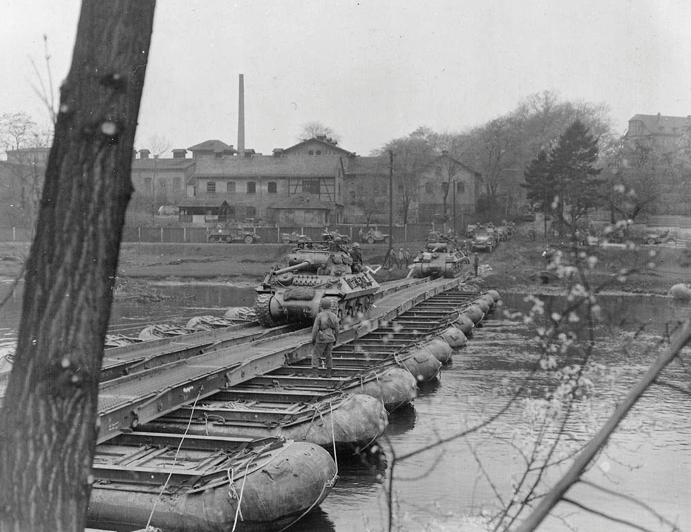 The U.S. Army 607th Tank Destroyer Battalion crosses the Saale River on a pontoon bridge near Saalfeld, Germany in April 1945. (U.S. Army Photograph.)