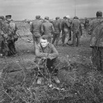 German prisoners, in a variety of uniforms, behind barbed wire in the Anzio beachhead, Italy, February 1944.