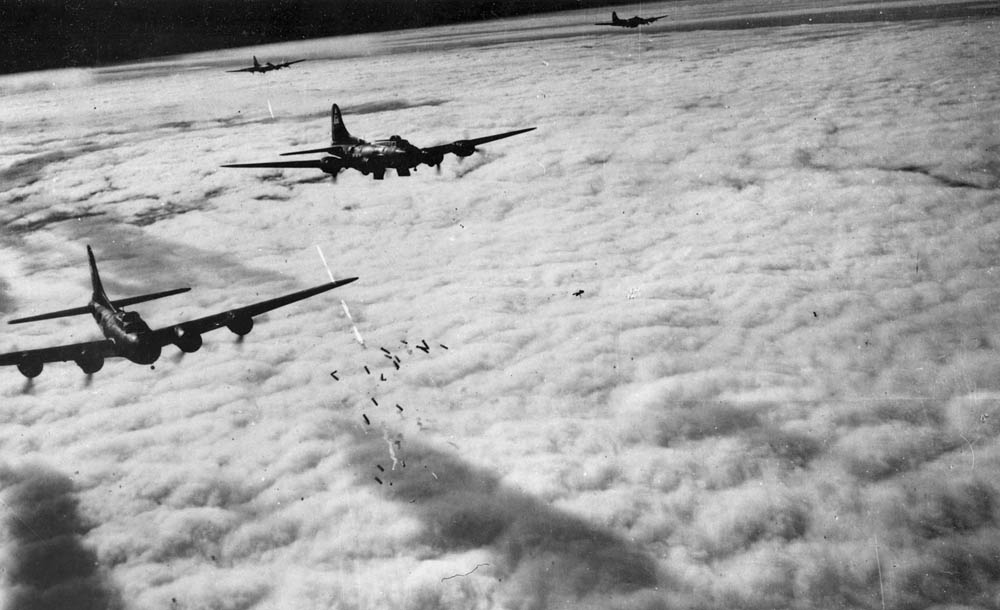 Boeing B-17 Flying Fortresses conduct a bombing mission through heavy clouds over Bremen, Germany in November 1943.