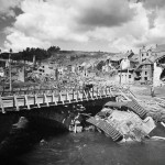 Destroyed town of Houffalize, Belgium including an overturned German Panther tank in the river after the Battle of the Bulge.