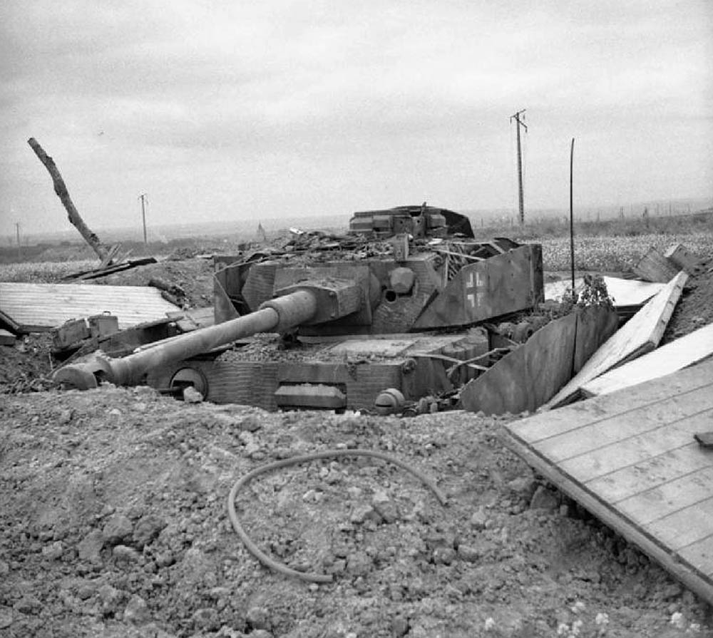 A knocked-out German Panzer IV tank dug into a hull-down position in Normandy during summer of 1944.