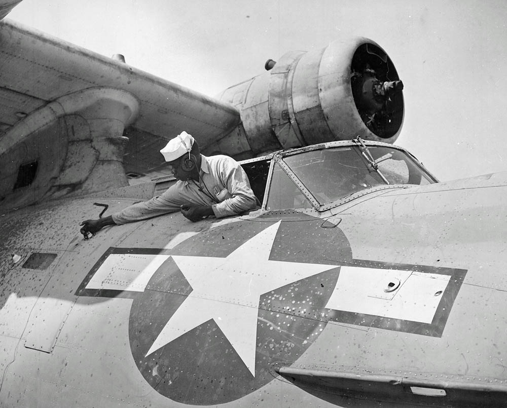 Mechanics perform maintenance work on a PBY flying boat at NAS Seattle, April 1944. (U.S. Navy Photograph.)