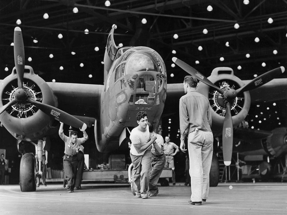 Factory workers pull a completed Douglas A-20 attack bomber off the assembly line at the Long Beach manufacturing plant, October 1942. (U.S. National Archives and Records Administration Photograph.)