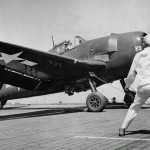 U.S. Navy sailors on the escort carrier USS Kasaan Bay launch a Grumman F6F-5 Hellcat of Fighting Squadron 74 (VF-74) during the invasion of Southern France. (U.S. Navy Photograph.)