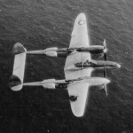 A pilot from 333rd Ftr Sq, 318th FG flies his damaged P-38 Lightning Ripper back to Saipan after an attack on Iwo Jima. (U.S. Air Force Photograph.)