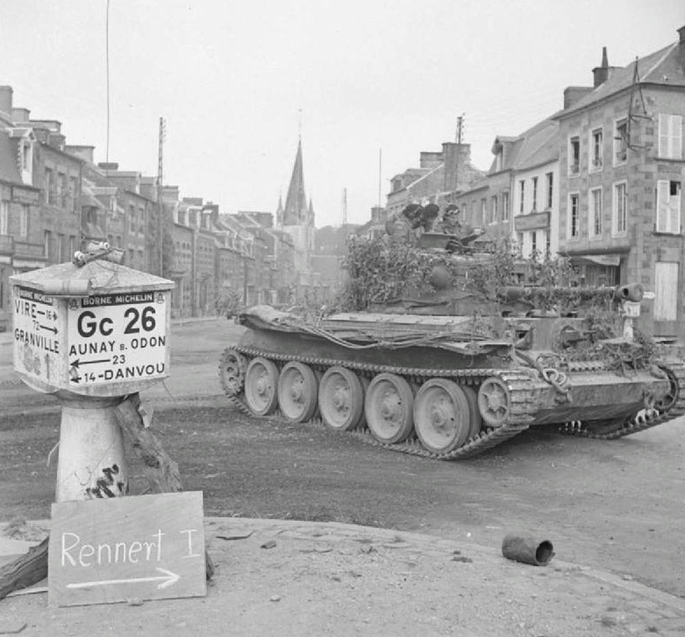 A Cromwell tank from the 2nd Northamptonshire Yeomanry, 11th Armoured Division drives through Vassy, France in August 1944. (Imperial War Museum Photograph.)