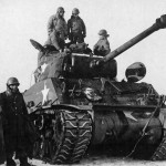 Pilots from the 354th Fighter Group inspect an M4 Sherman tank of the 4th Armored Division during a tour of the front. (U.S. Air Force Photograph.)