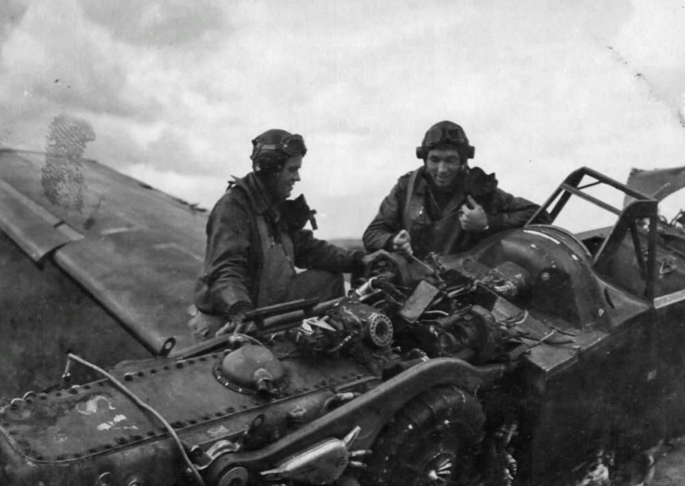 Two U.S. fighter pilots from 9th Air Force examine a wrecked German Me 109 fighter.