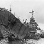 Light cruiser USS St. Louis with torpedo damage to her bow after the Battle of Kolombangara, photographed while under repair at Tulagi in July 1943. USS Vestal (AR-4) is alongside. (U.S. Navy Photograph.)