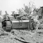 Two British soldiers inspect a German StuG III assault gun knocked-out near Cassino, Italy in May 1944. (Imperial War Museum Photograph.)