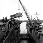 A Grumman F4F-4 Wildcat fighter is transferred from USS Kitty Hawk to USS Long Island at Fila Harbor, New Hebrides in August 1942. (Official U.S. Navy Photograph.)