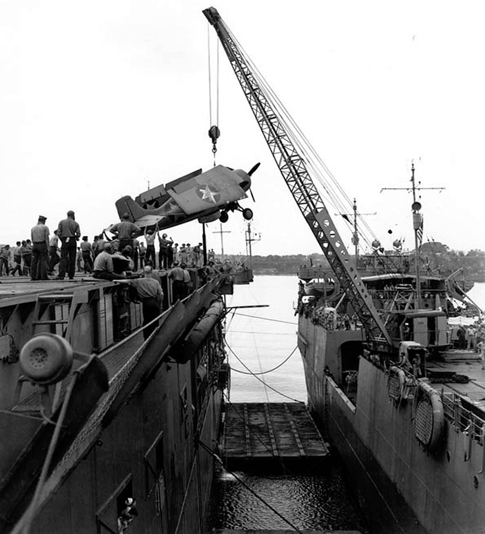 A Grumman F4F-4 Wildcat fighter is transferred from USS Kitty Hawk to USS Long Island at Fila Harbor, New Hebrides in August 1942. (Official U.S. Navy Photograph.)