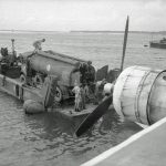 An RAF Short Sunderland GR Mark V of No. 205 Squadron moored off Direction Island, Cocos Islands prepares to refuel from a petrol tanker on board a Tank Landing Craft. (Imperial War Museums Photograph.)