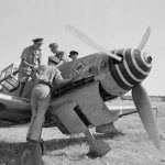 RAF pilots examine an abandoned Messerschmitt Me 109G of JG 53 at Comiso, Sicily in 1943. (Imperial War Museum Photographs.)