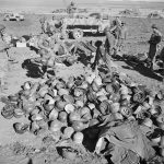 U.S. Army soldiers sort through a pile of German helmets left behind by the 10th and 15th Panzer Divisions after the Axis surrender in Tunisia. (U.S. Library of Congress Photograph.)