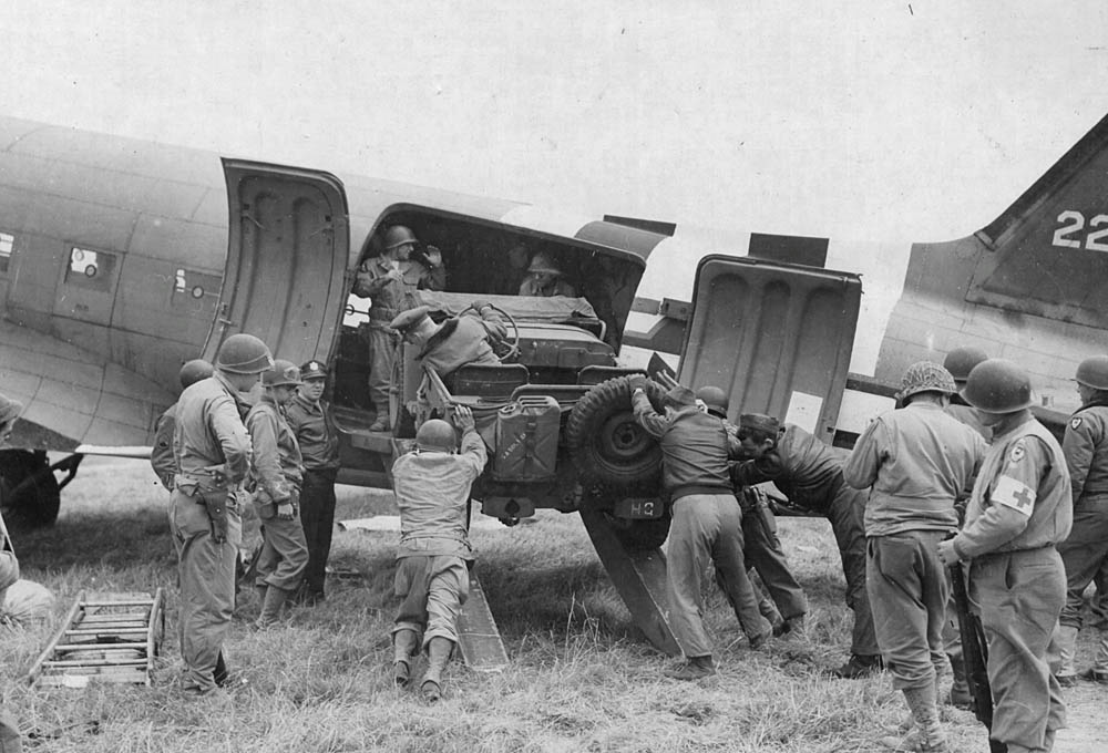 In France, Allied soldiers unload a jeep from a Douglas C-47 Skytrain military transport aircraft. (U.S. Air Force Photograph.)