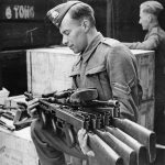 Lend-lease Thompson submachine guns arriving in England are unpacked by an ordnance corporal. (U.S. National Archives Photograph.)