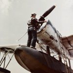 Maintenance work is performed on a Vought OS2U Kingfisher on a U.S. Navy cruiser off the coast of Japan in March 1945. (U.S. Navy Photograph.)