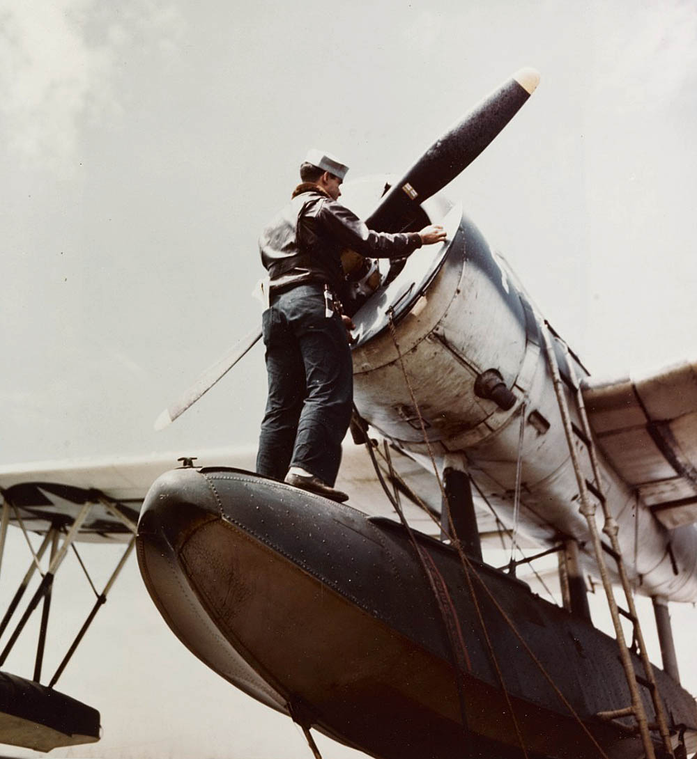 Maintenance work is performed on a Vought OS2U Kingfisher on a U.S. Navy cruiser off the coast of Japan in March 1945. (U.S. Navy Photograph.)