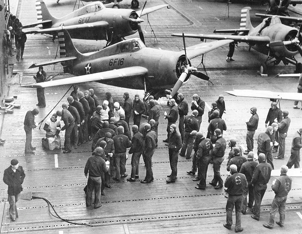 Sailors gather in front of Grumman F4F-4 Wildcats from Fighting Squadron 6 (VF-6) aboard the aircraft carrier USS Enterprise (CV-6) in April 1942. (U.S. Navy Photograph.)