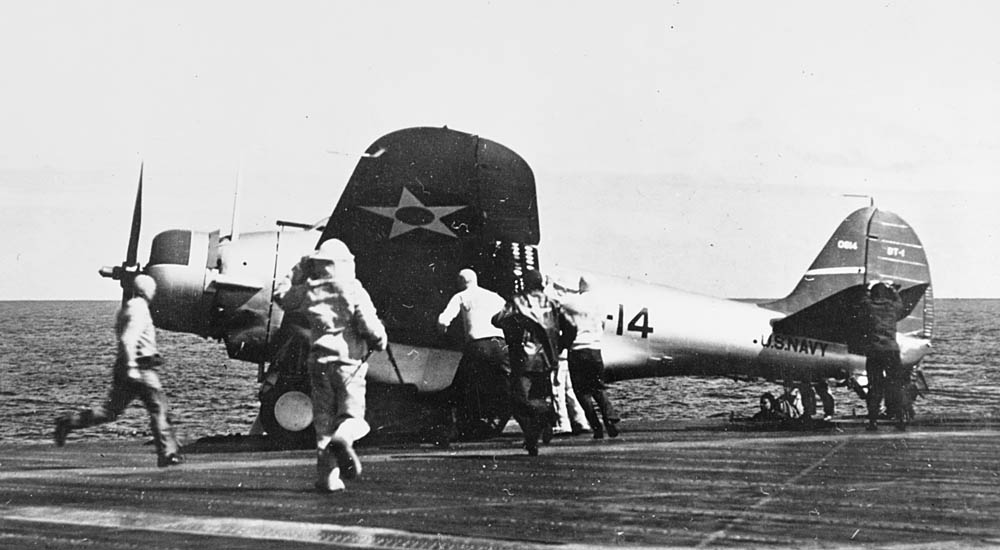 Sailors on the USS Yorktown rush to aid a Northrop BT-1 bomber of Bombing Squadron Five (VB-5) after a landing accident, circa 1940. (Official U.S. Navy Photograph.)