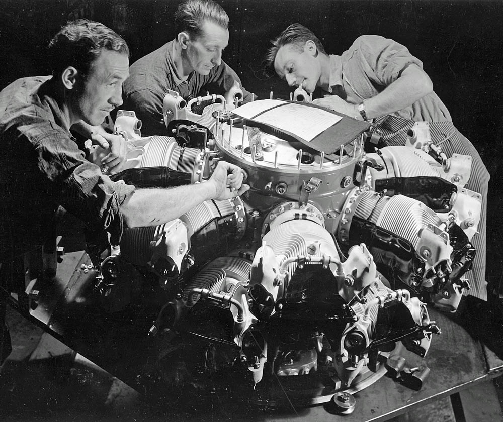 Factory workers assemble the cylinders on an early production Pratt and Whitney R-2800 Double Wasp radial aircraft engine in June 1942. (U.S. National Archives and Records Admin. Photograph.)