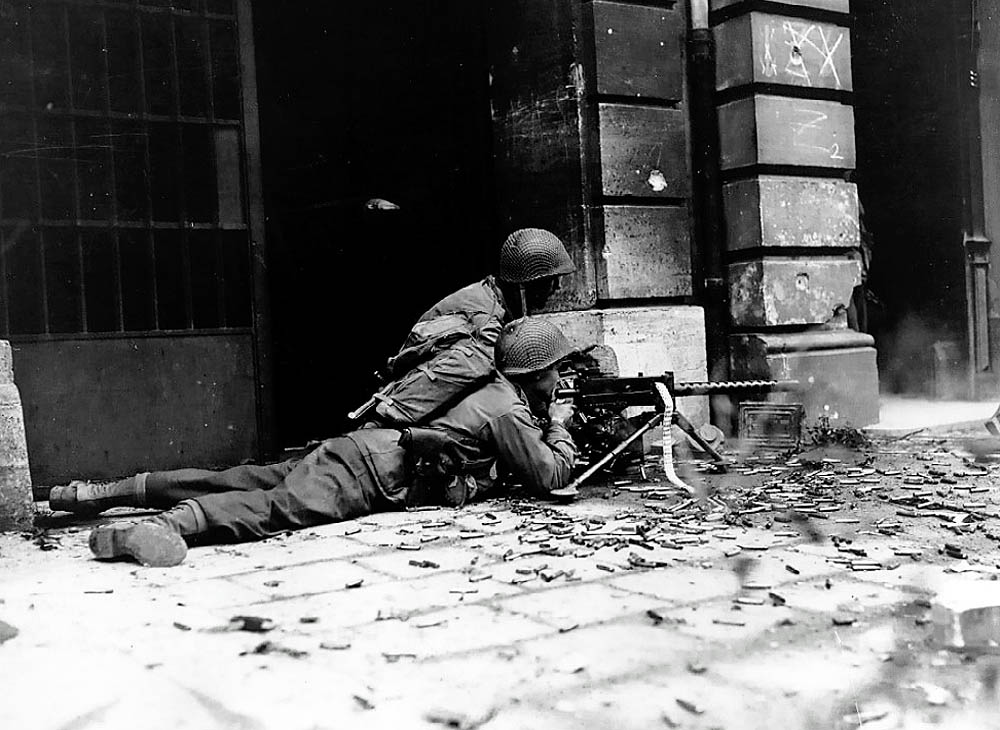 A U.S. Army machine gun crew from the 26th Infantry fire a M1919 Browning during street fighting in Aachen, Germany in October 1944. (U.S. Army Photograph.)