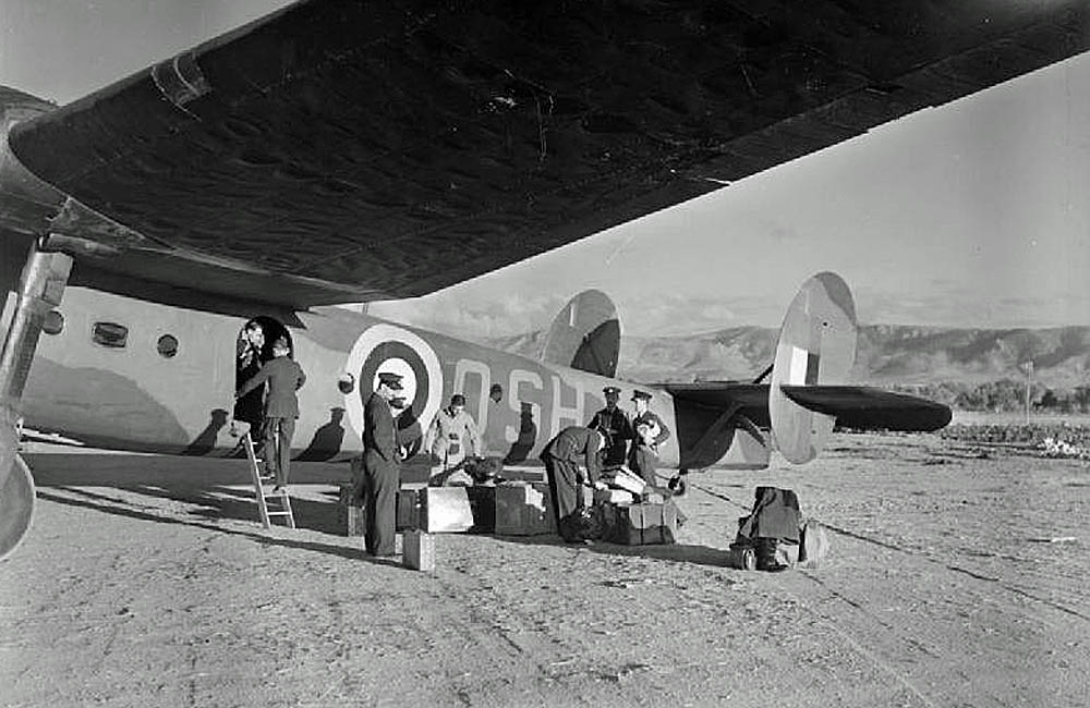 British officers unload luggage and equipment from a Bristol Bombay of No. 216 Squadron after landing at Maleme, Crete in 1941. (Imperial War Museum Photograph.)