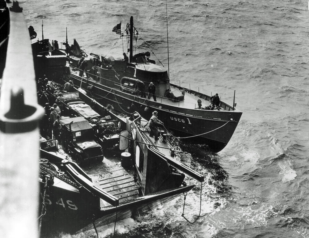 The U.S. Coast Guard cutter USCG-1 waits off Omaha Beach on the morning of D-Day tied up alongside an LCT. (U.S. Coast Guard Photograph.)