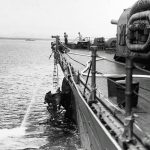 Sailors repair torpedo damage to the heavy cruiser USS Chicago (CA-29) near Guadalcanal after the Battle of Savo Island in August 1942. (Official U.S. Navy Photograph.)