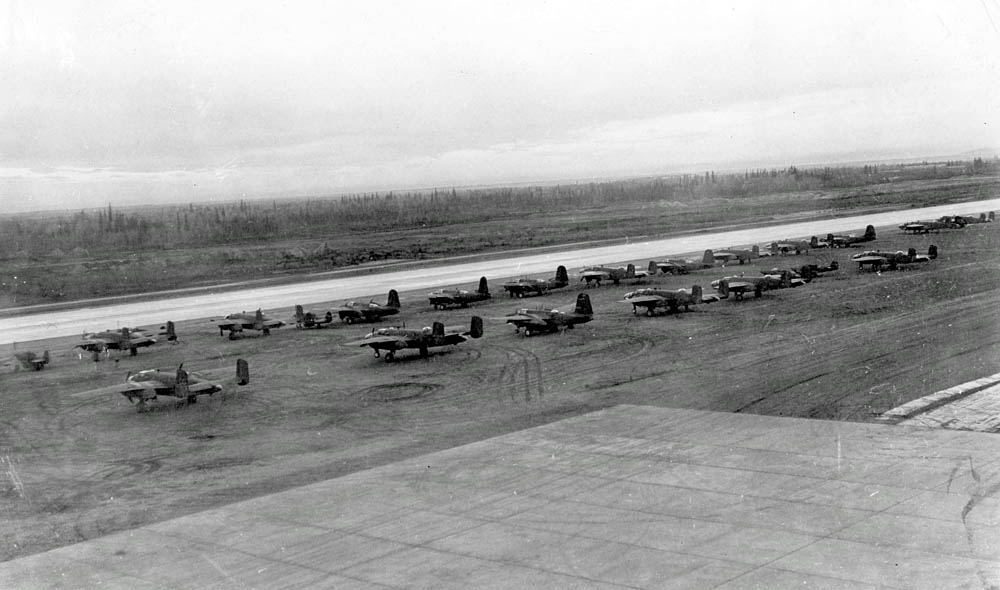 New B-25s and P-39s, bound for Russia as part of the Lend-Lease program, wait on the runway at Ladd Field, Alaska in September 1942. (U.S. Air Force Photograph.)