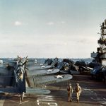 Dauntless dive bombers and Grumman Wildcat fighters are parked on the deck of escort carrier USS Santee (ACV-29) during Operation Torch in November 1942. (Official U.S. Navy Photograph.)