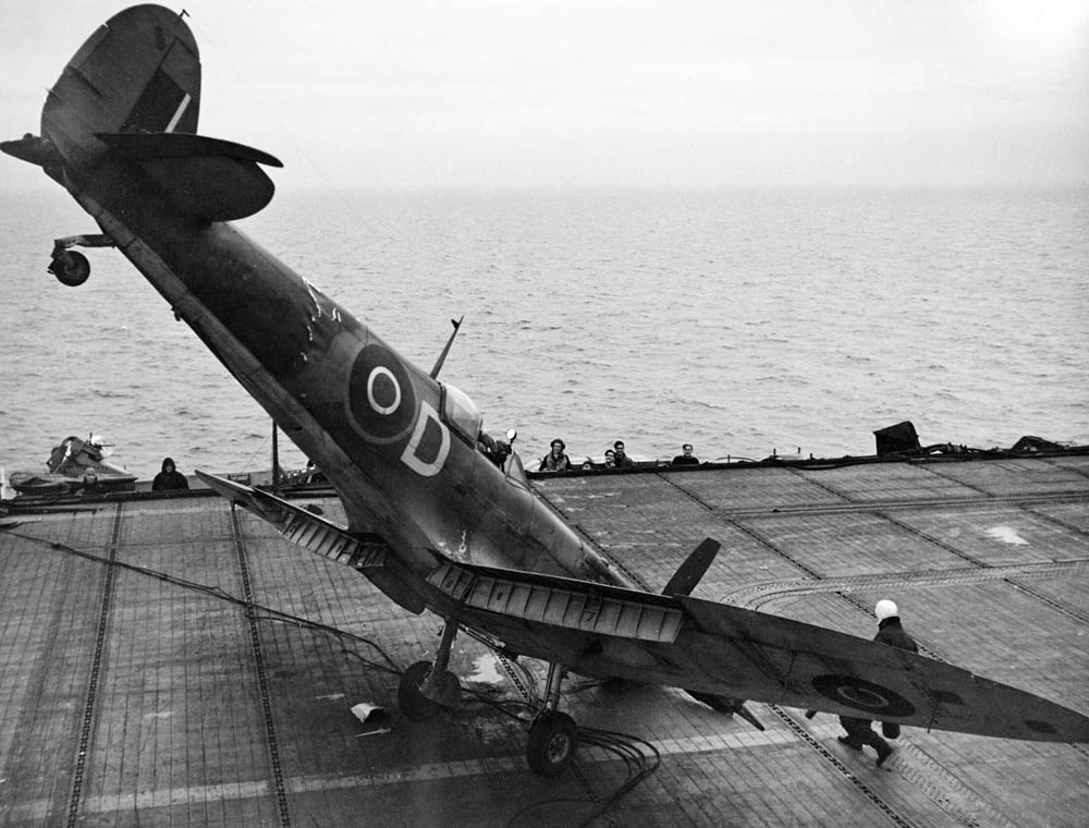 A Supermarine Seafire fighter sits on the flight deck of HMS Smiter after a nose over landing accident in 1944. (Imperial War Museums Photograph.)