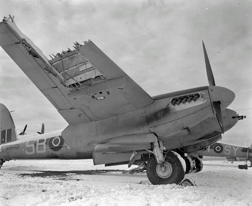 Damaged de Havilland Mosquito FB Mark VI of RAAF No. 464 Squadron based at Hunsdon, Hertfordshire, parked at Friston Emergency Landing Ground, Sussex in February 1944. (Imperial War Museum Photograph.)