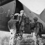 Paratroopers, with 82nd Airborne Division shoulder patches, board a plane on Karouan Airfield, near Sousse, Tunisia. (U.S. Air Force Photograph.)