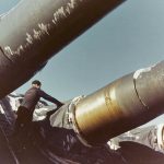 A sailor on the battleship USS Alabama cleans ice and snow off the battleship's 16-inch guns during the ship's North Atlantic shakedown cruise, December 1942 to January 1943. (U.S. Navy Photograph.)