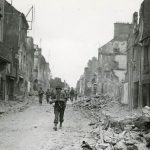 Soldiers in the advance guard of the U.S. Army's 29th Infantry Division march into St. Lo, France on July 20, 1944. The 29th ID captured the city as part of the XIX Corps of the First Army. (U.S. Signal Corps Photograph.)