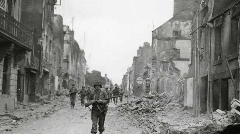 Soldiers in the advance guard of the U.S. Army's 29th Infantry Division march into St. Lo, France on July 20, 1944. The 29th ID captured the city as part of the XIX Corps of the First Army. (U.S. Signal Corps Photograph.)